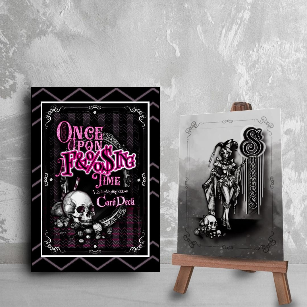 OUAFT card deck box with a skull design and the game's logo text on a gray textured background. Next to the box is a single "Success" card with a sketch of a fae performer.