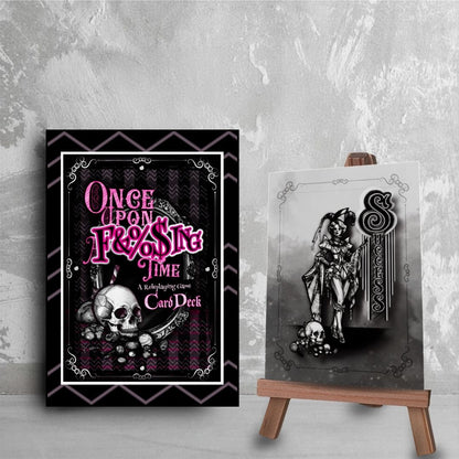 OUAFT card deck box with a skull design and the game's logo text on a gray textured background. Next to the box is a single "Success" card with a sketch of a fae performer.